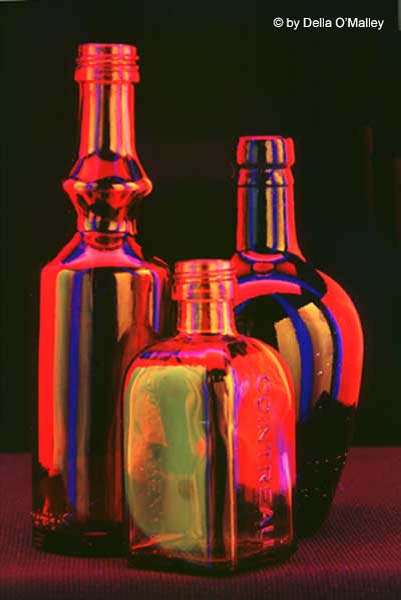December 2003 Projected Image - Della O'Malley - Bottles Collecting Fluorescent Colors